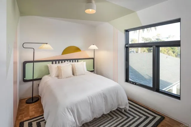 a bedroom with a bed and window