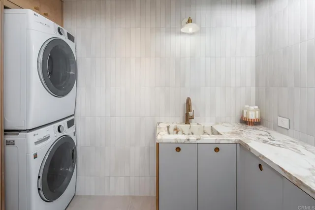 a bathroom with a sink vanity and washer