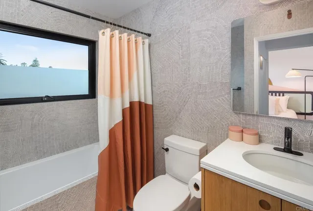 a bathroom with a sink a toilet and tub