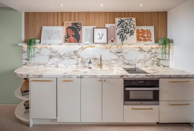 a view of kitchen cabinets stainless steel appliances and wooden floor