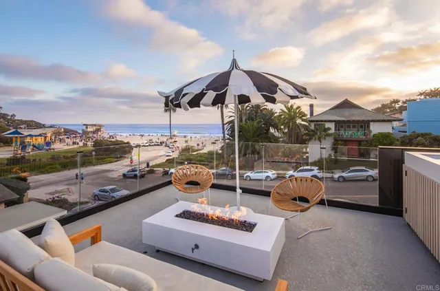 a roof deck with couch and chairs