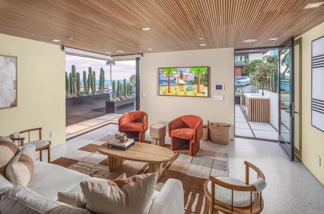 a living room with furniture and a floor to ceiling window