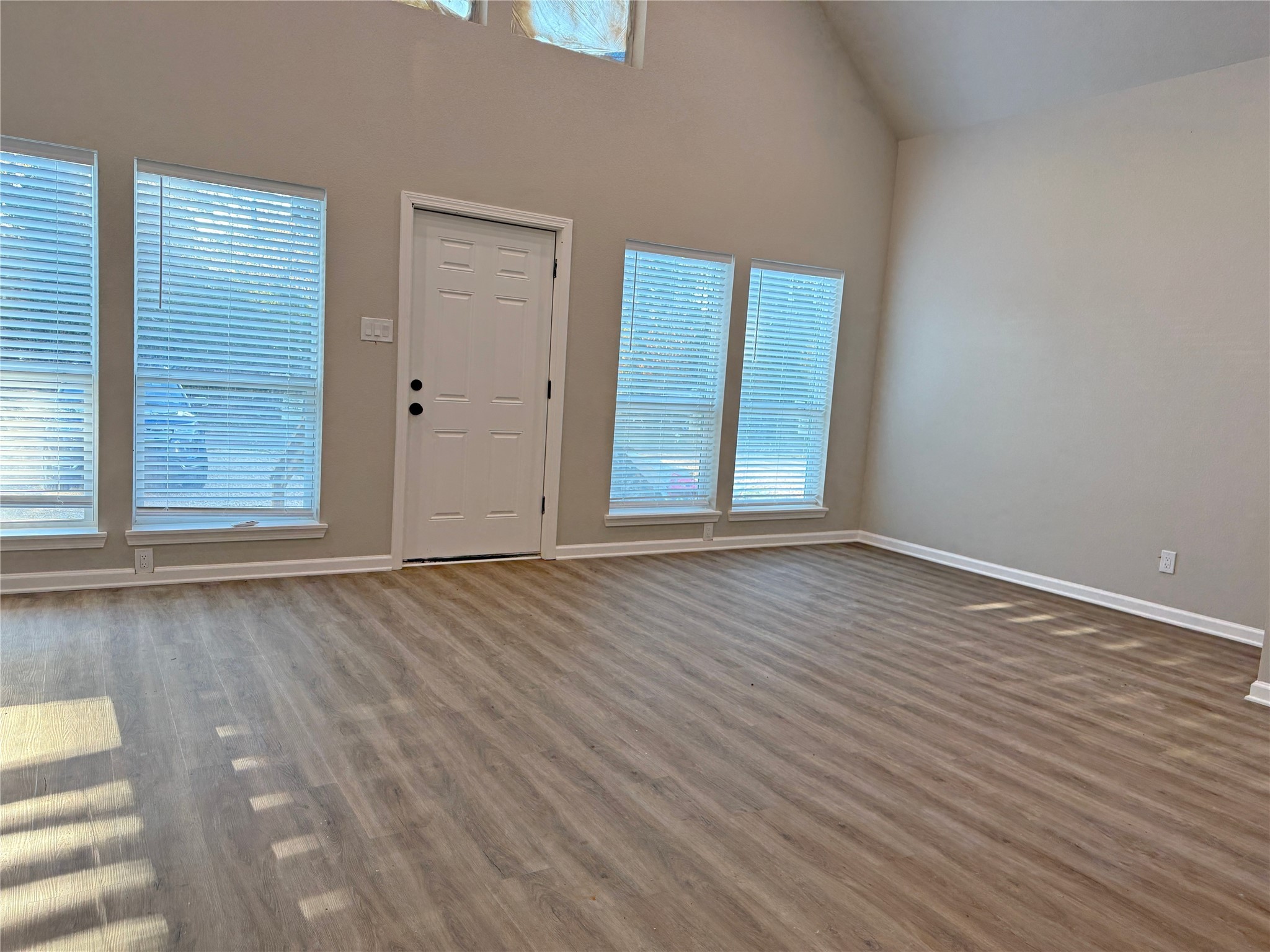 91 Willow Oak Lane Point Blank, TX 77364 - Photo 22 of 27 an empty room with wooden floor and windows