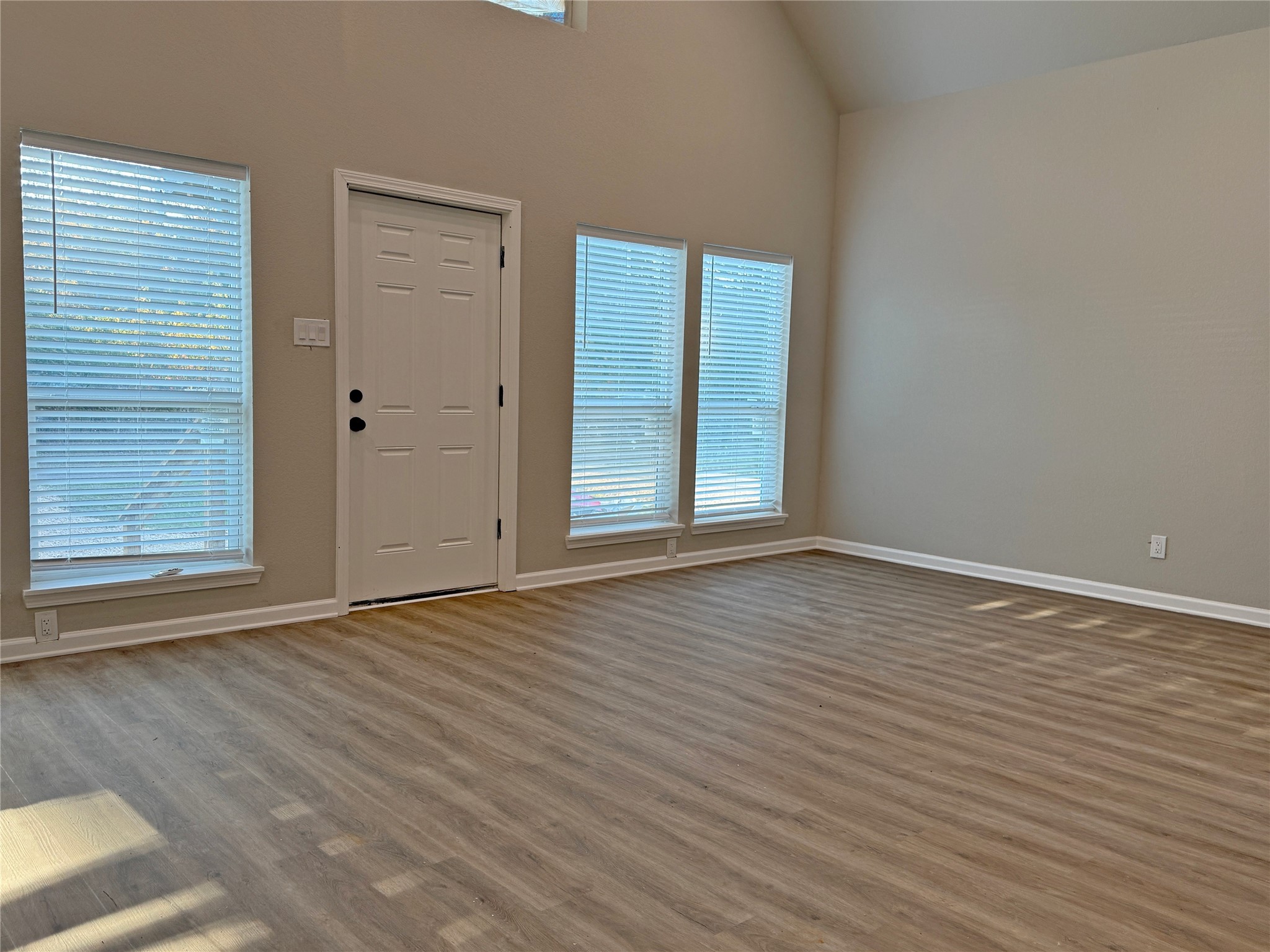 91 Willow Oak Lane Point Blank, TX 77364 - Photo 23 of 27 a view of an empty room with wooden floor and a window