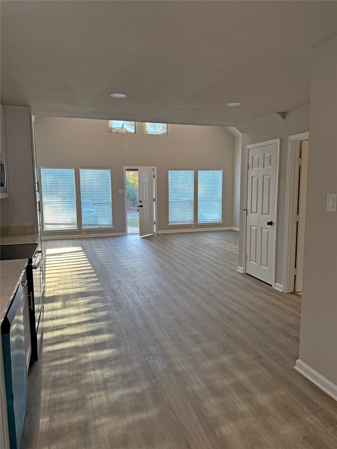 91 Willow Oak Lane Point Blank, TX 77364 - Photo 24 of 27 a view of a hallway with wooden floor and a living room