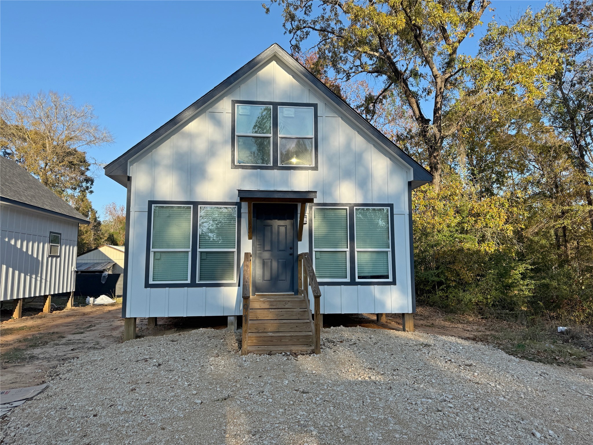 91 Willow Oak Lane Point Blank, TX 77364 - Photo 25 of 27 a front view of a house with a yard and garage