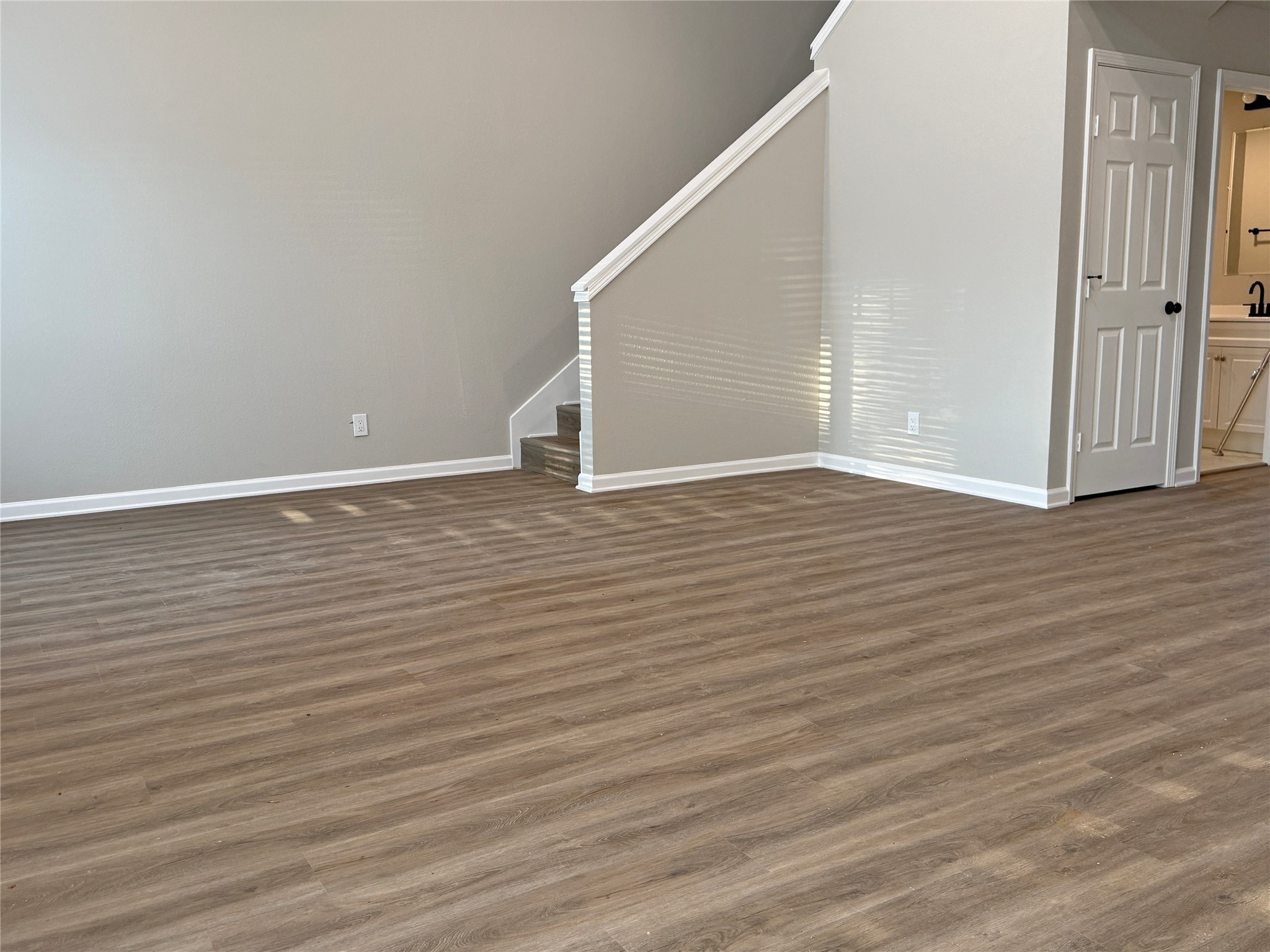 91 Willow Oak Lane Point Blank, TX 77364 - Photo 9 of 27 a view of an empty room with wooden floor and a window