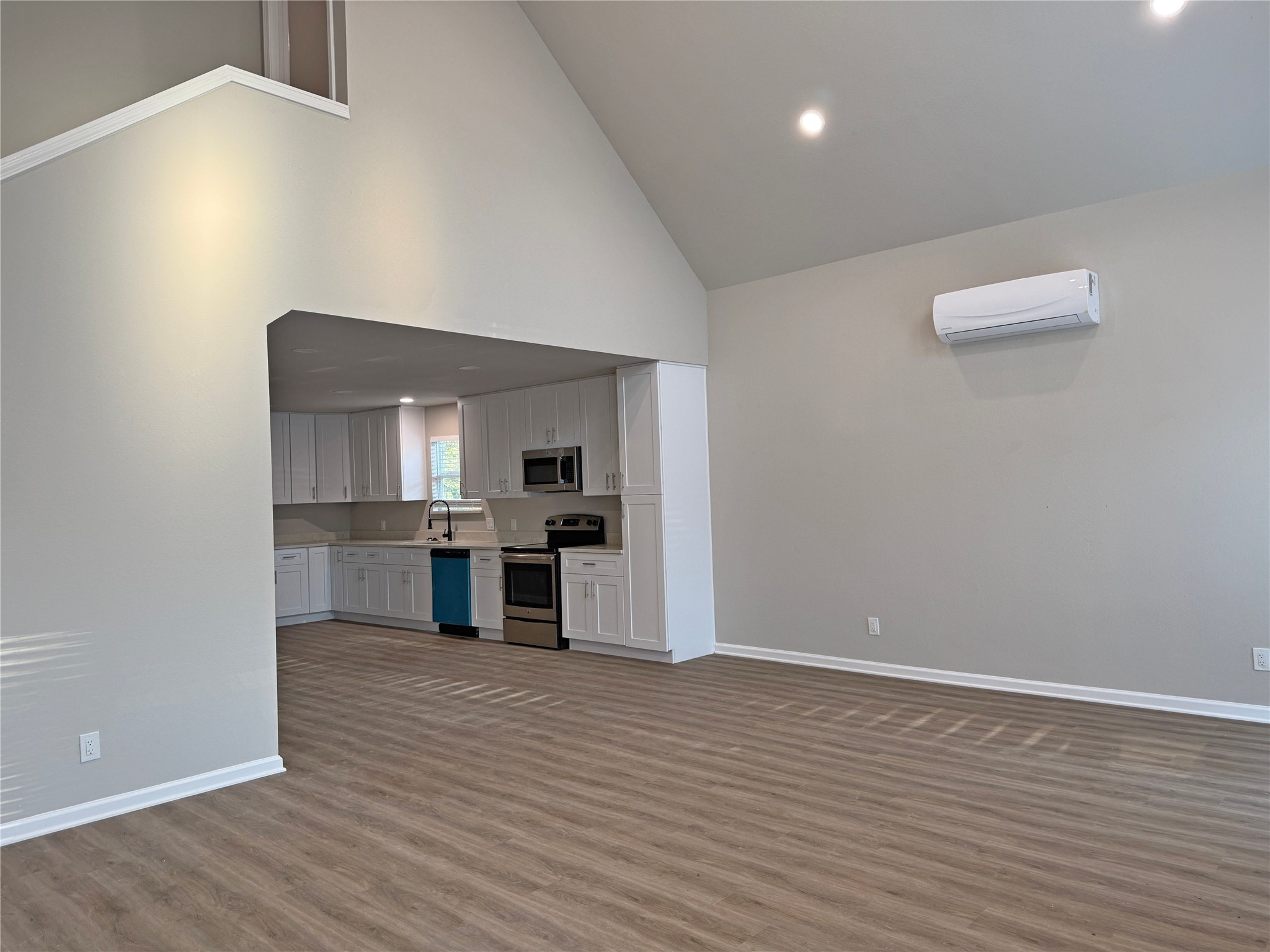 91 Willow Oak Lane Point Blank, TX 77364 - Photo 10 of 27 a view of kitchen and empty room with wooden floor