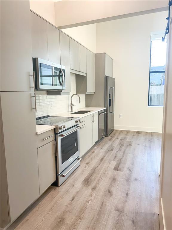 a kitchen with stove cabinets and refrigerator