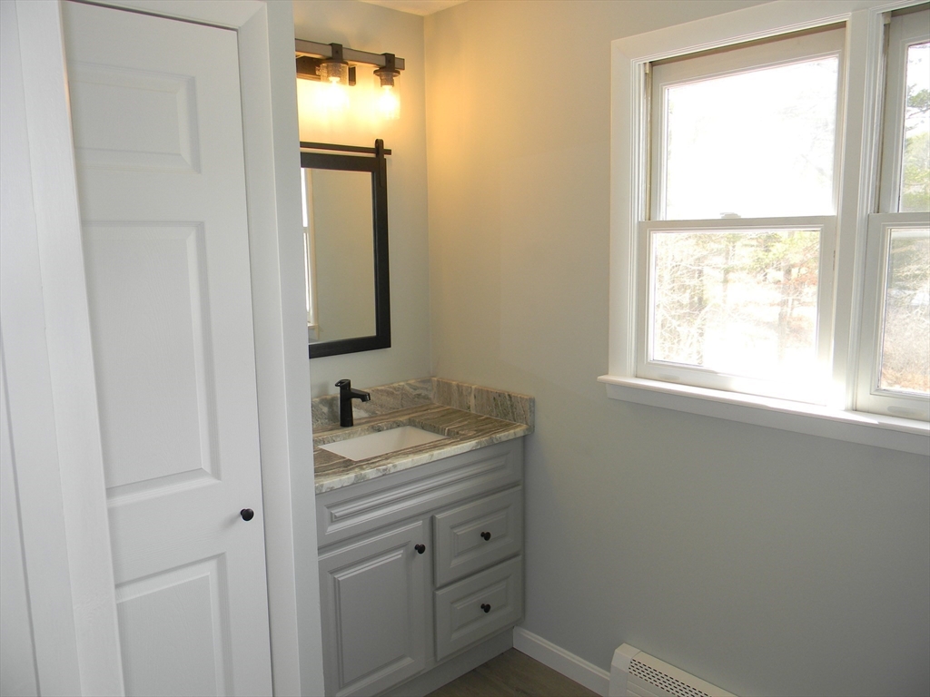 1 Lenox Street Athol, MA 01331 - Photo 21 of 37 a bathroom with a granite countertop sink and a window