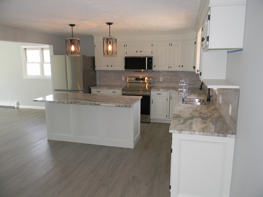 1 Lenox Street Athol, MA 01331 - Photo 3 of 37 a kitchen with a sink microwave and cabinets