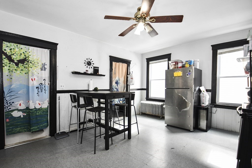 97 Arthur Street Worcester, MA 01604 - Photo 13 of 42 a kitchen with stainless steel appliances granite countertop a refrigerator a sink a stove and a dining table
