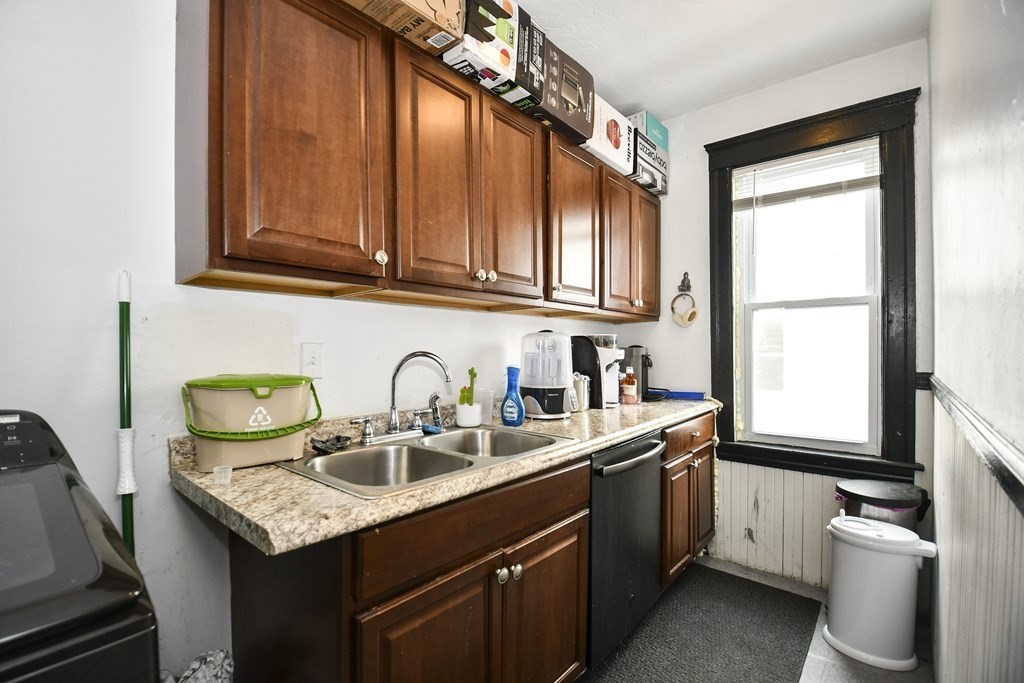 97 Arthur Street Worcester, MA 01604 - Photo 14 of 42 a kitchen with stainless steel appliances granite countertop a sink a stove and cabinets