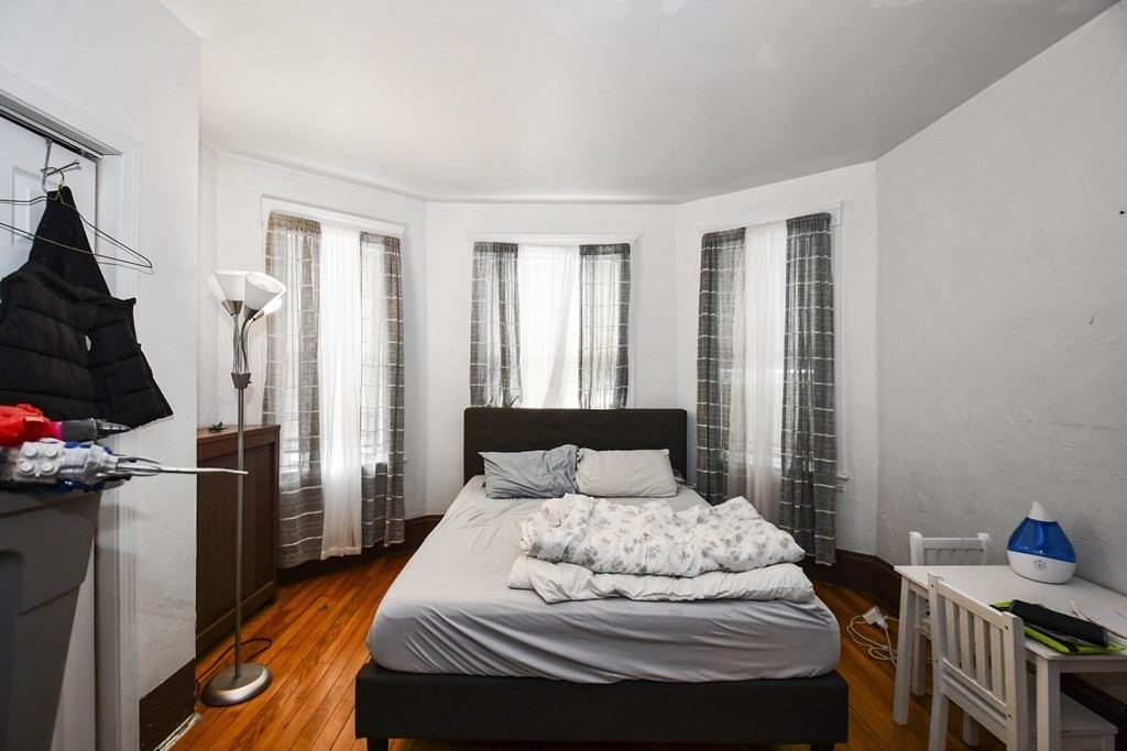 97 Arthur Street Worcester, MA 01604 - Photo 15 of 42 a bedroom with a bed and wooden floor