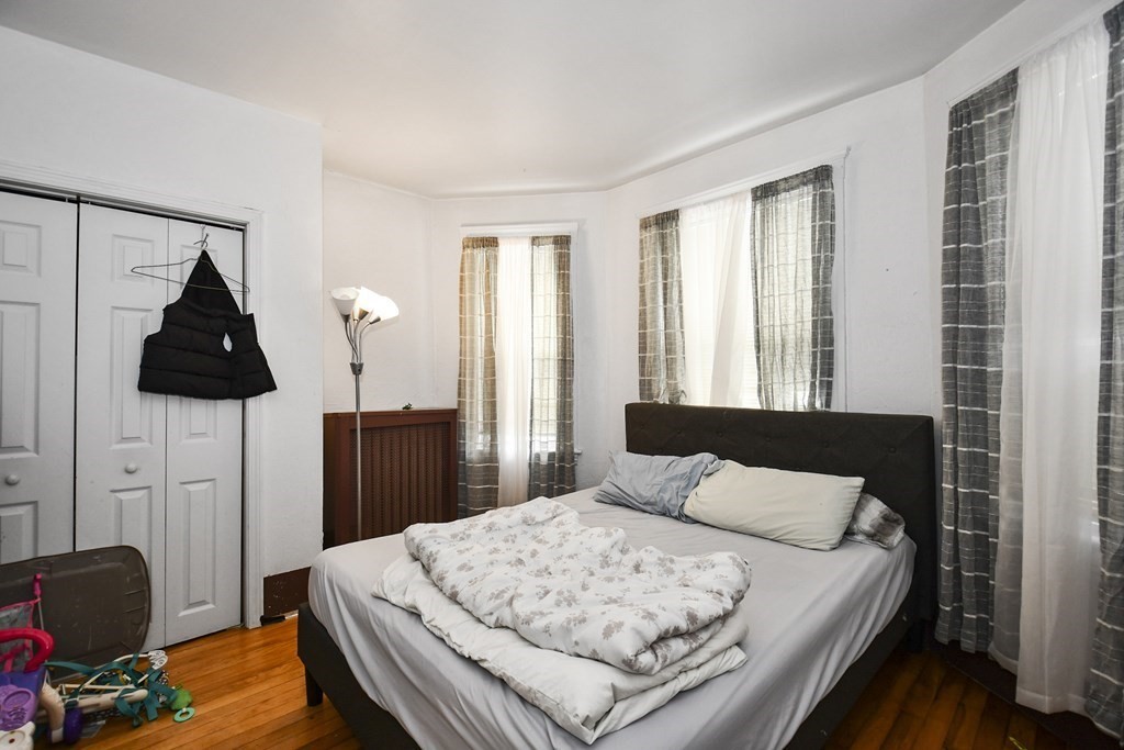 97 Arthur Street Worcester, MA 01604 - Photo 16 of 42 a bedroom with a bed and wooden floor