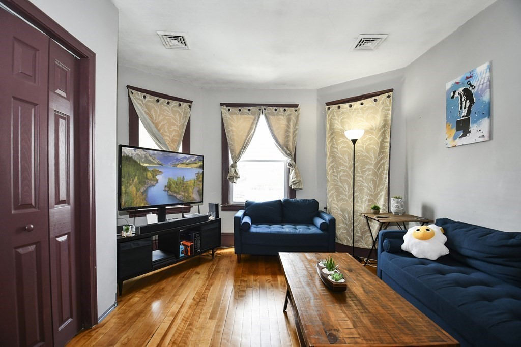 97 Arthur Street Worcester, MA 01604 - Photo 2 of 42 a living room with furniture and a flat screen tv