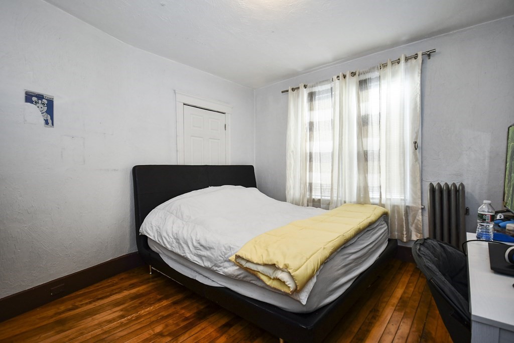 97 Arthur Street Worcester, MA 01604 - Photo 21 of 42 a bed sitting in a bedroom next to a window