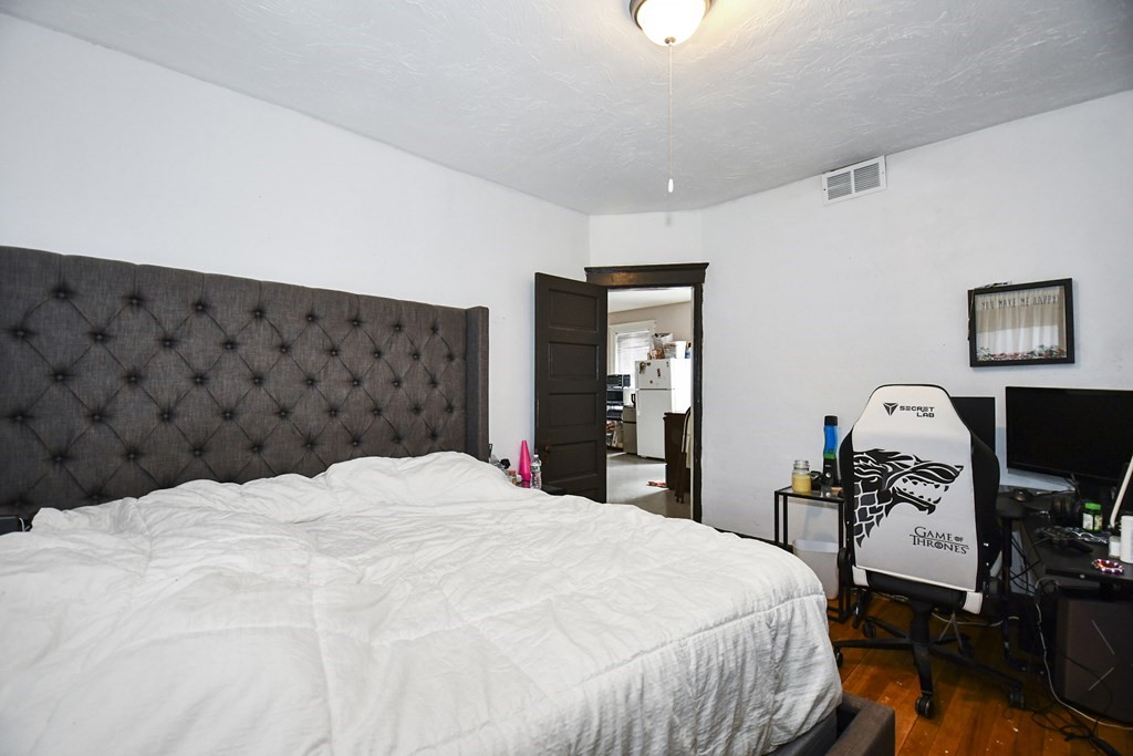 97 Arthur Street Worcester, MA 01604 - Photo 28 of 42 a bedroom with a bed and a dresser