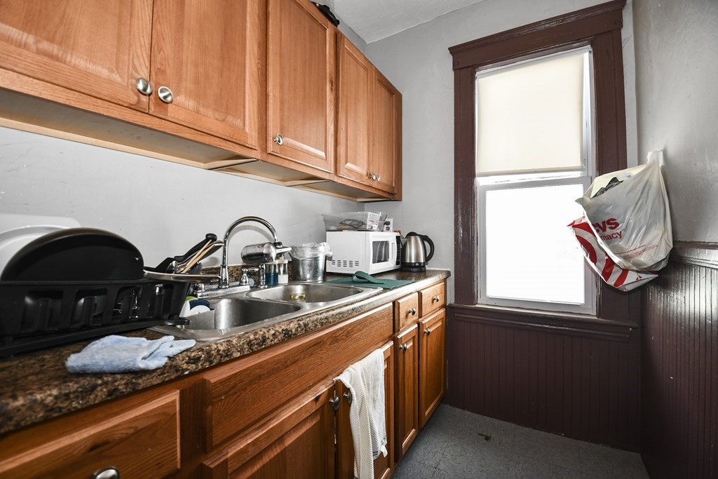 97 Arthur Street Worcester, MA 01604 - Photo 7 of 42 a kitchen with granite countertop a sink a stove and cabinets