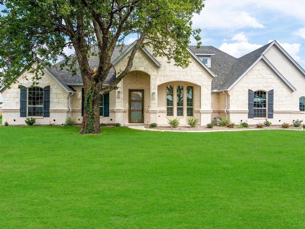 a front view of house with yard and green space