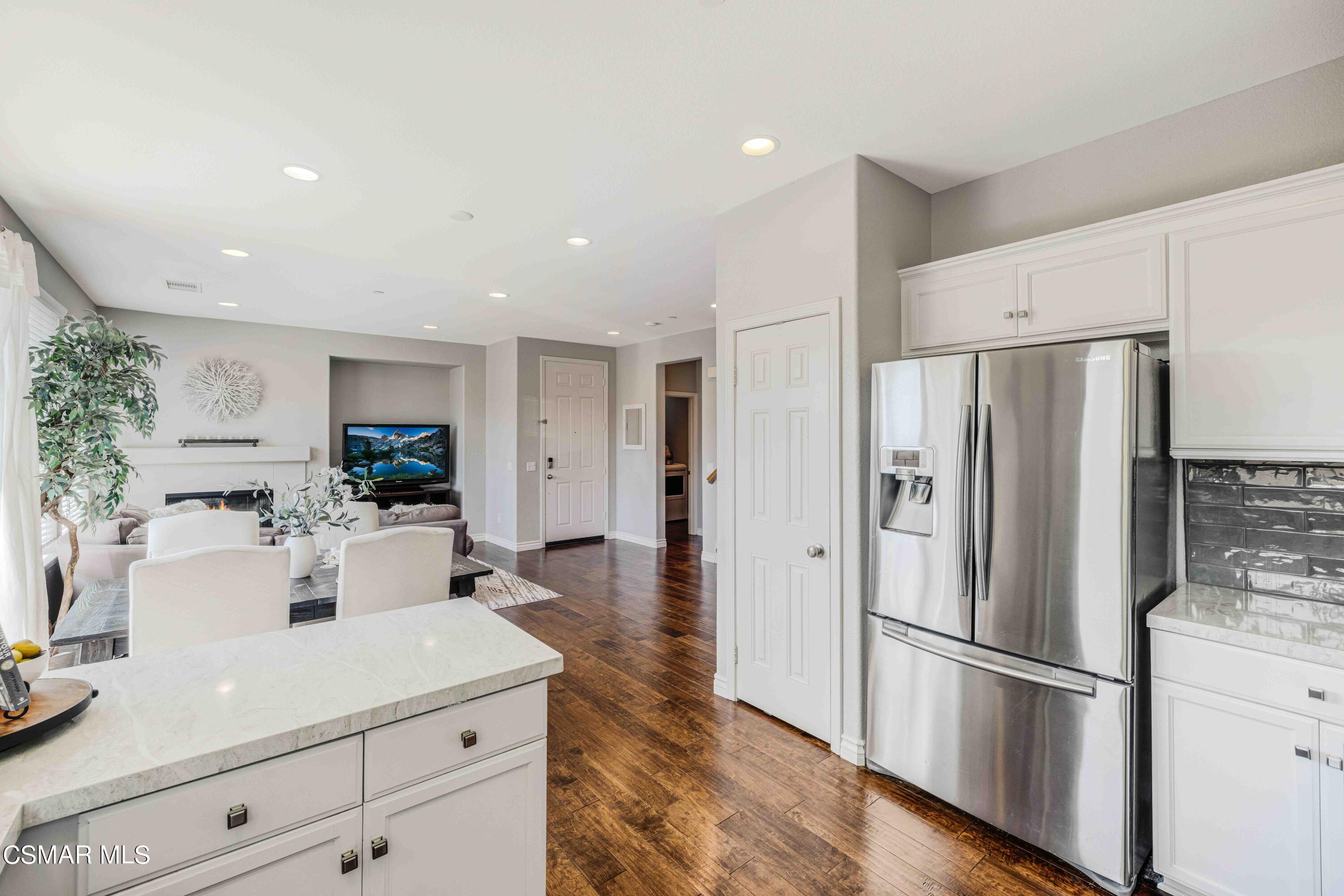 6802 Simmons Way Moorpark, CA 93021 - Photo 11 of 36 a kitchen with refrigerator and white cabinets