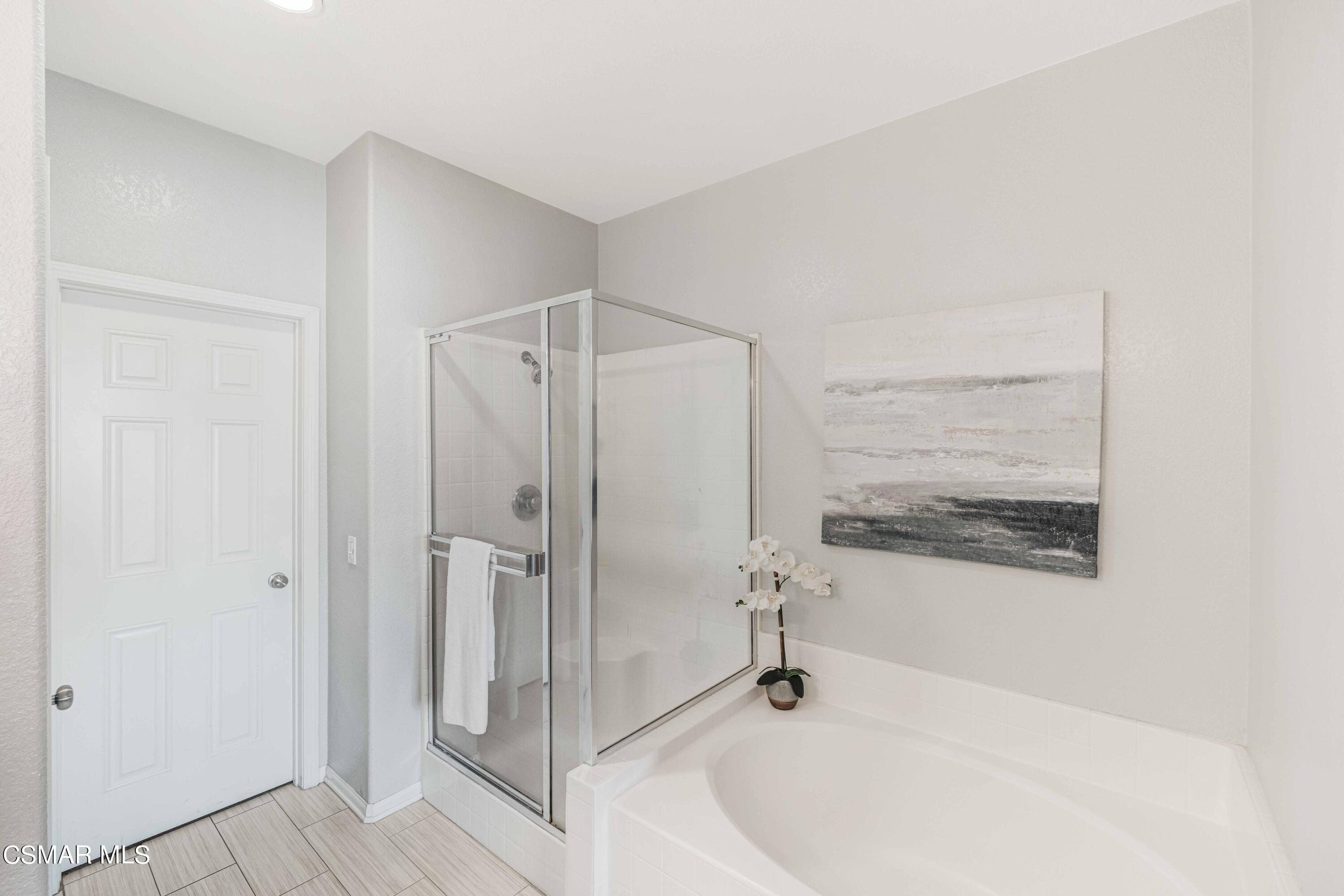 6802 Simmons Way Moorpark, CA 93021 - Photo 12 of 36 a bathroom with a bathtub and a shower