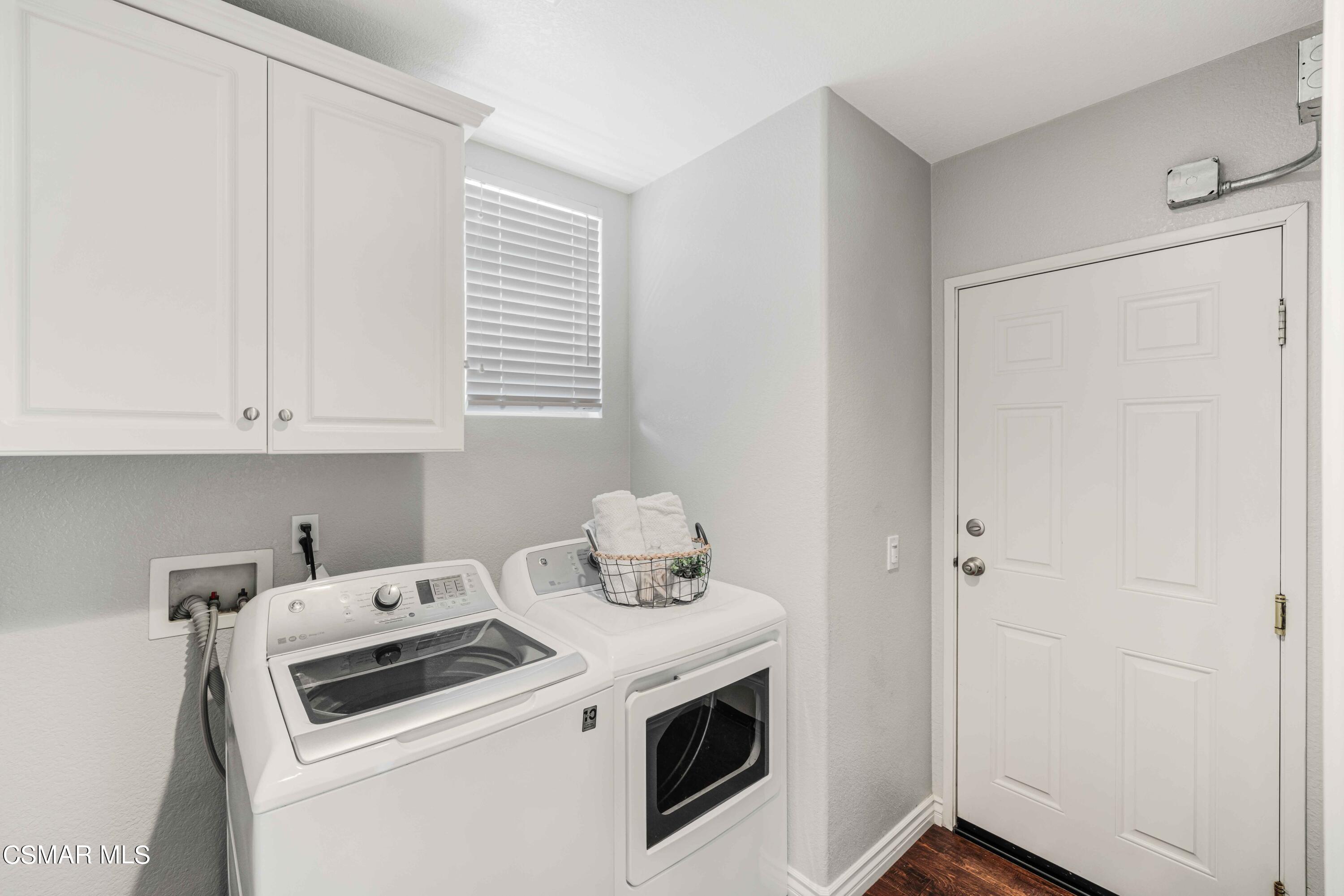 6802 Simmons Way Moorpark, CA 93021 - Photo 13 of 36 a view of washer and dryer with kitchen in the background