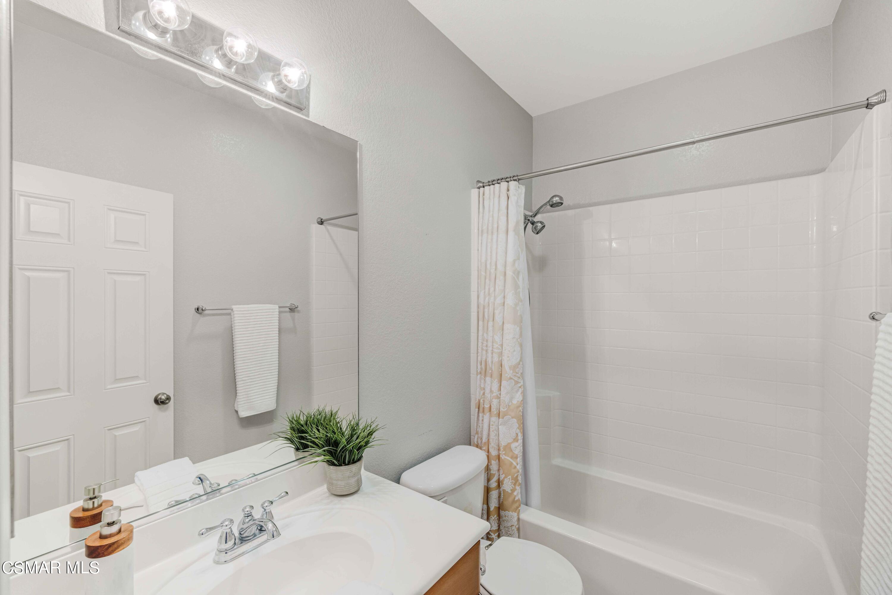 6802 Simmons Way Moorpark, CA 93021 - Photo 16 of 36 a bathroom with a tub shower sink and a toilet