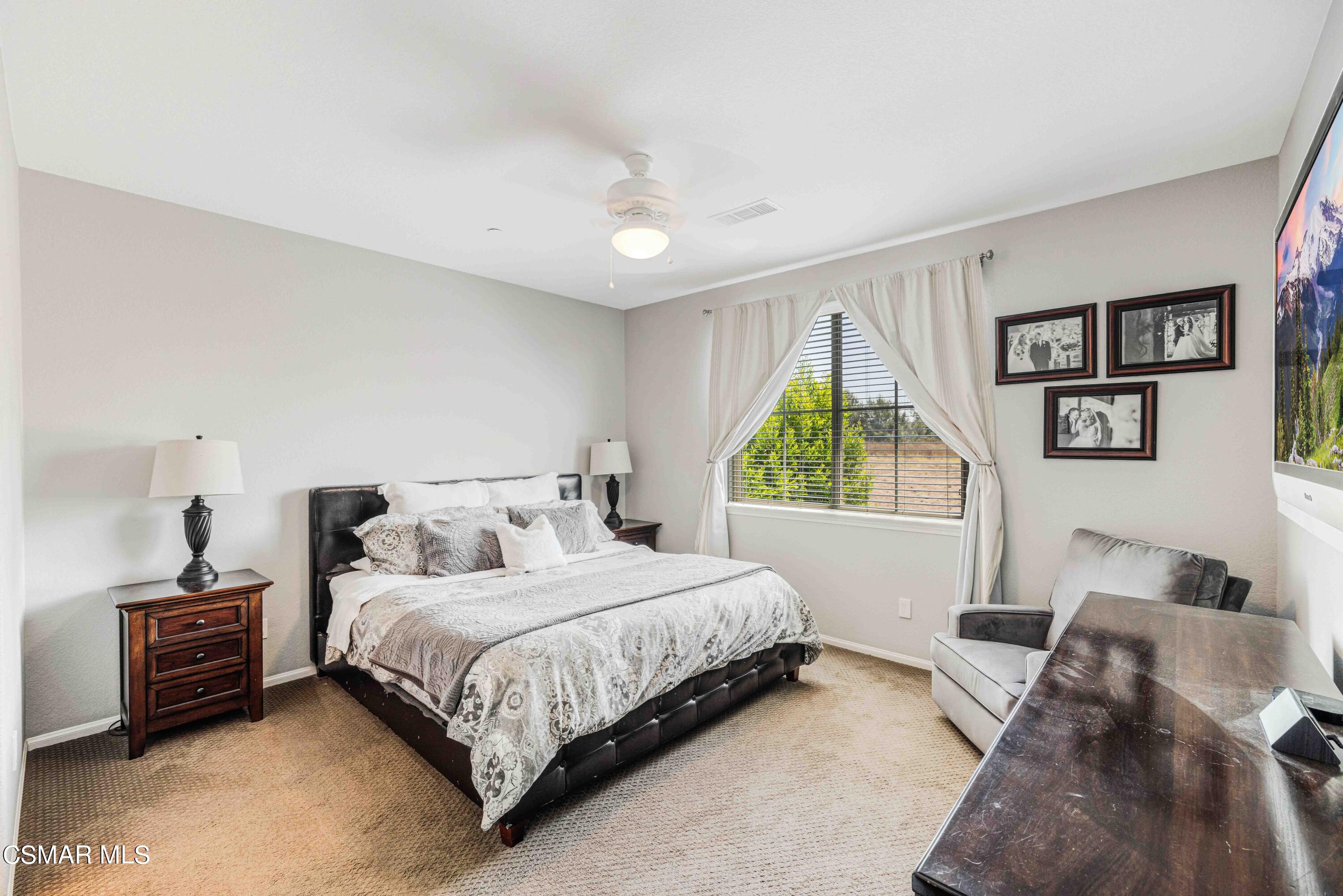 6802 Simmons Way Moorpark, CA 93021 - Photo 17 of 36 a bedroom with a bed a window and a couch