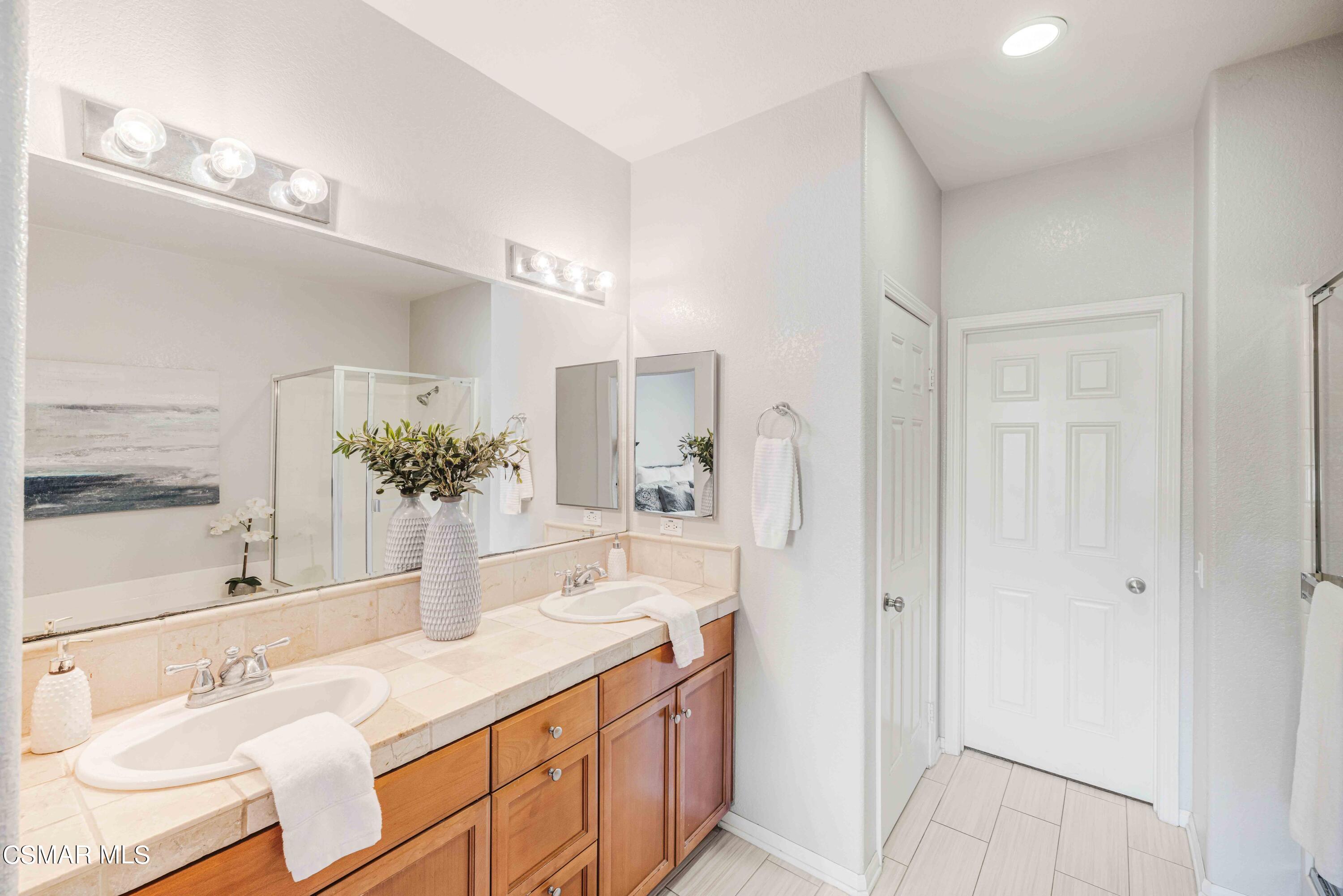 6802 Simmons Way Moorpark, CA 93021 - Photo 19 of 36 a bathroom with a sink and a mirror