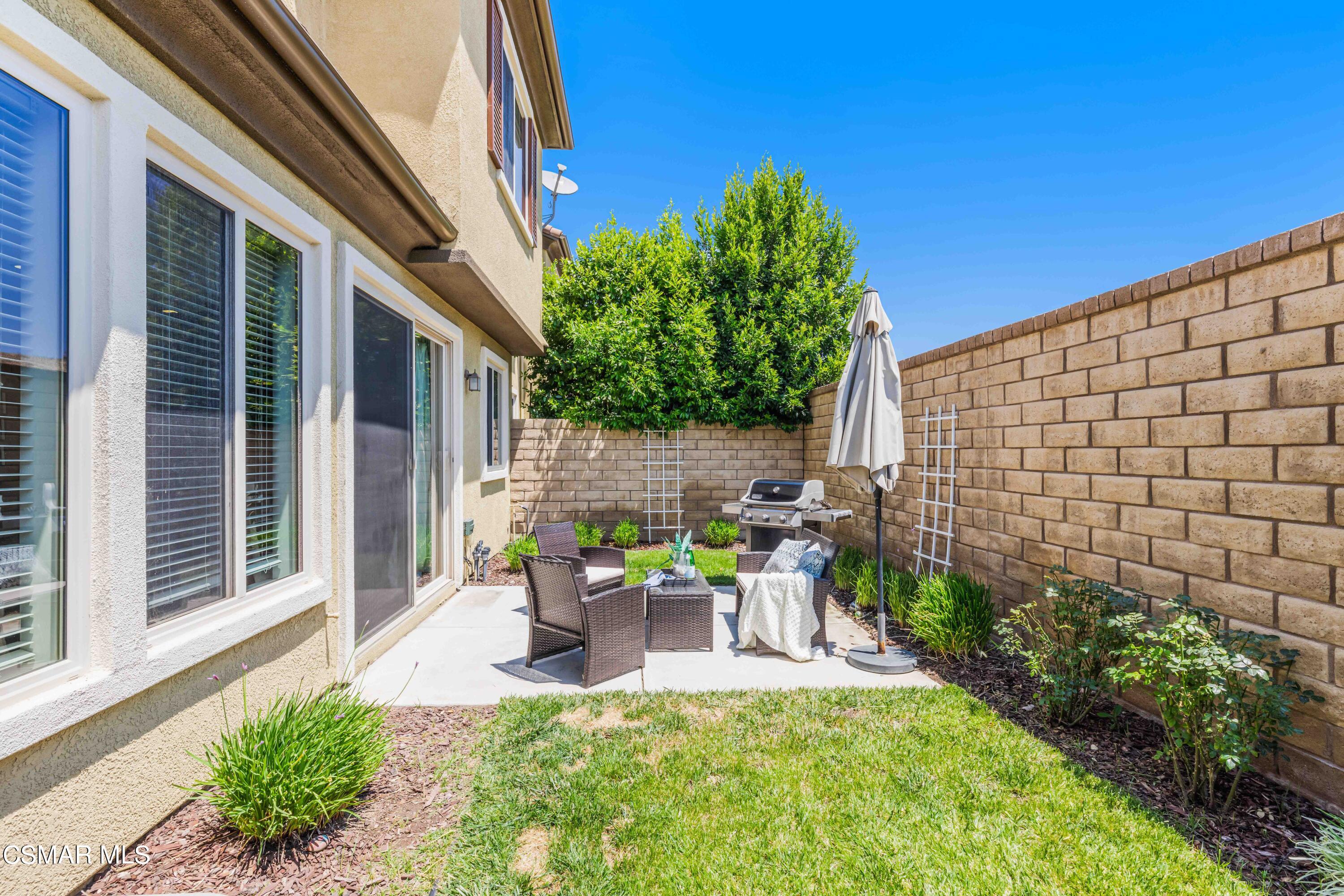 6802 Simmons Way Moorpark, CA 93021 - Photo 21 of 36 a view of a patio with table and chairs and potted plants