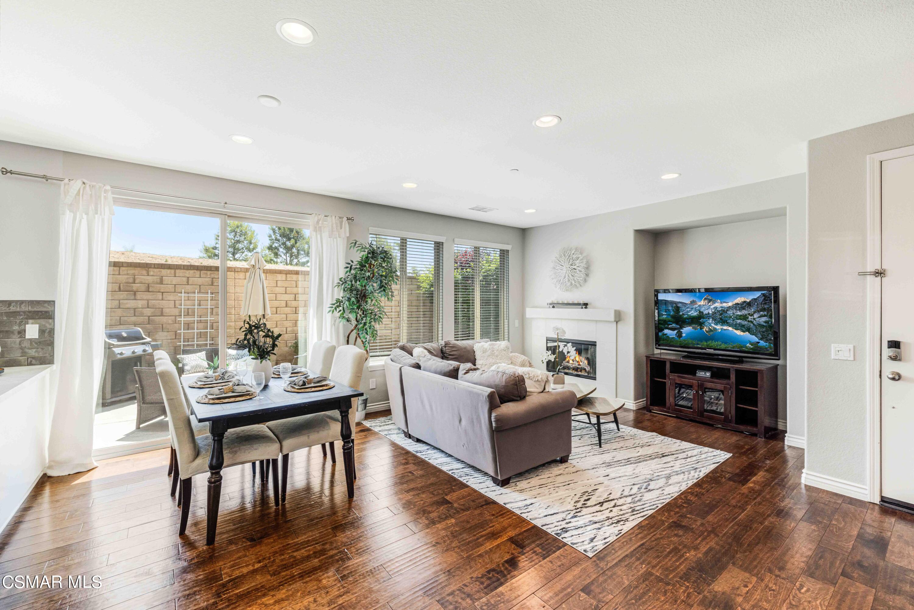 6802 Simmons Way Moorpark, CA 93021 - Photo 6 of 36 a living room with fireplace furniture and a flat screen tv