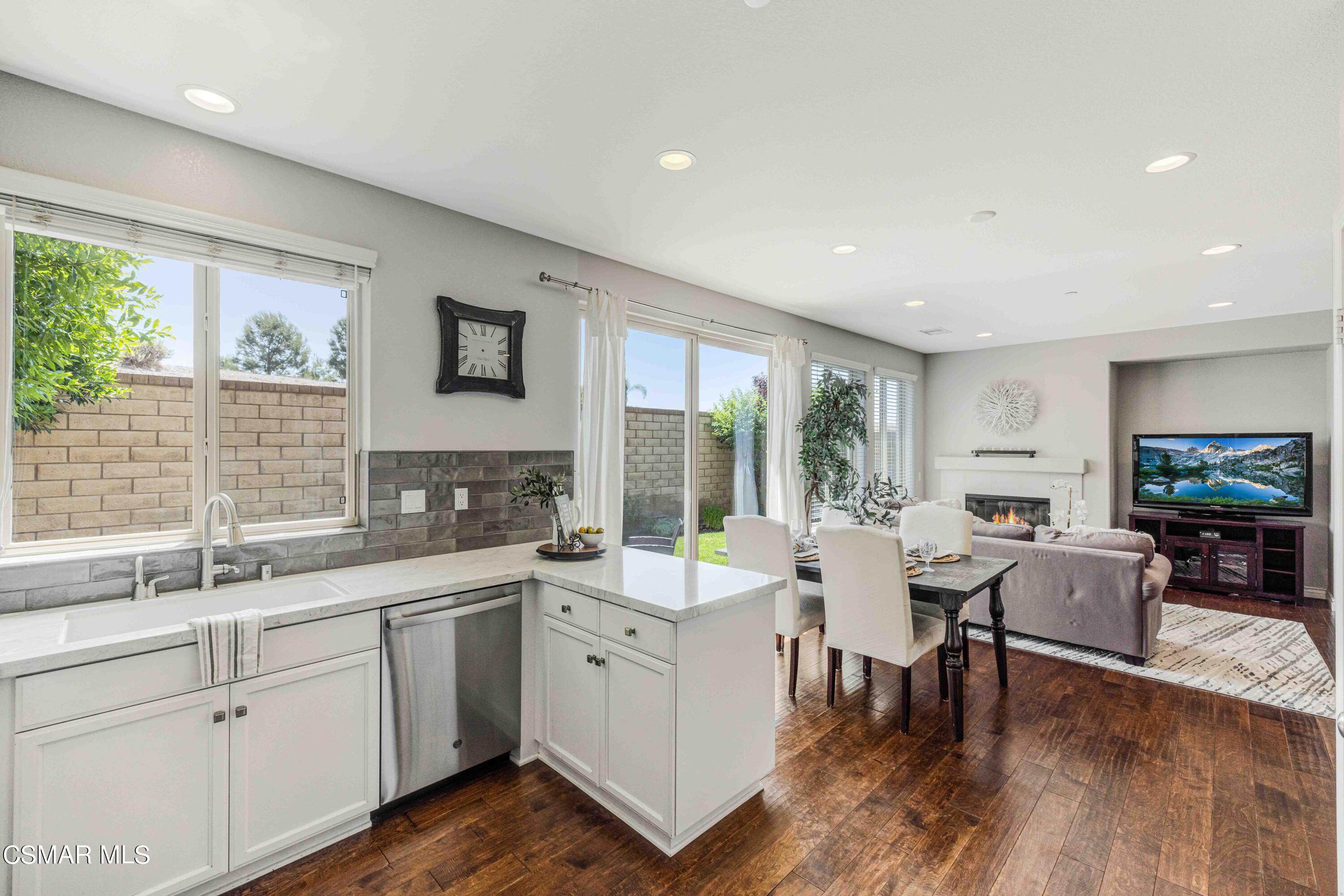 6802 Simmons Way Moorpark, CA 93021 - Photo 9 of 36 a large white kitchen with a large window appliances and furniture