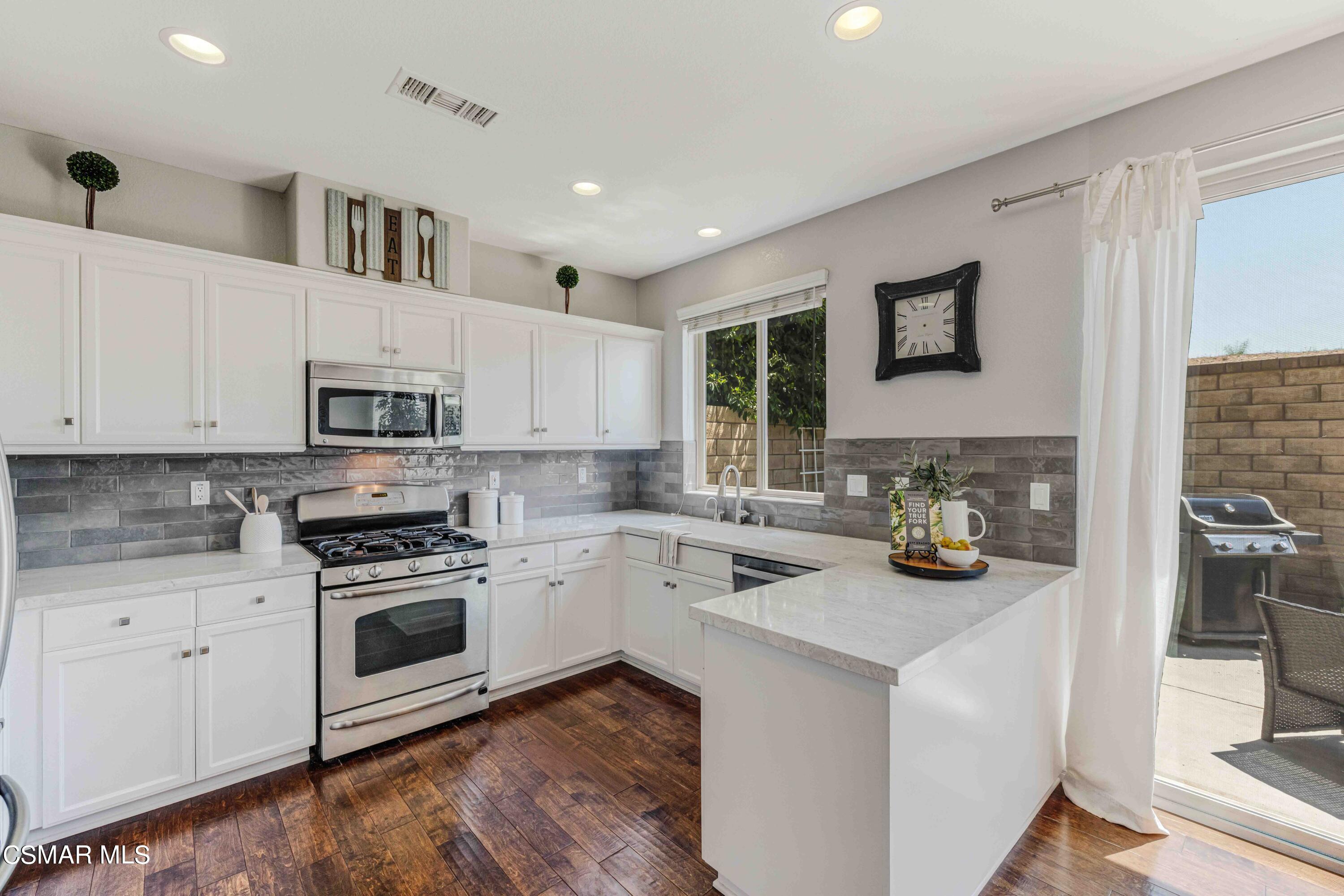 6802 Simmons Way Moorpark, CA 93021 - Photo 10 of 36 a kitchen with sink a stove and cabinets