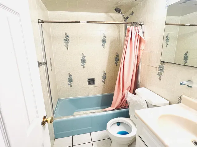 a bathroom with a bathtub toilet and shower