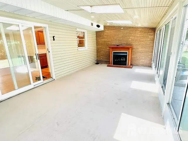 a view of a fireplace in an empty room