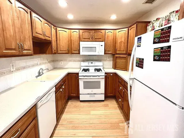 a kitchen with a stove a sink and a microwave