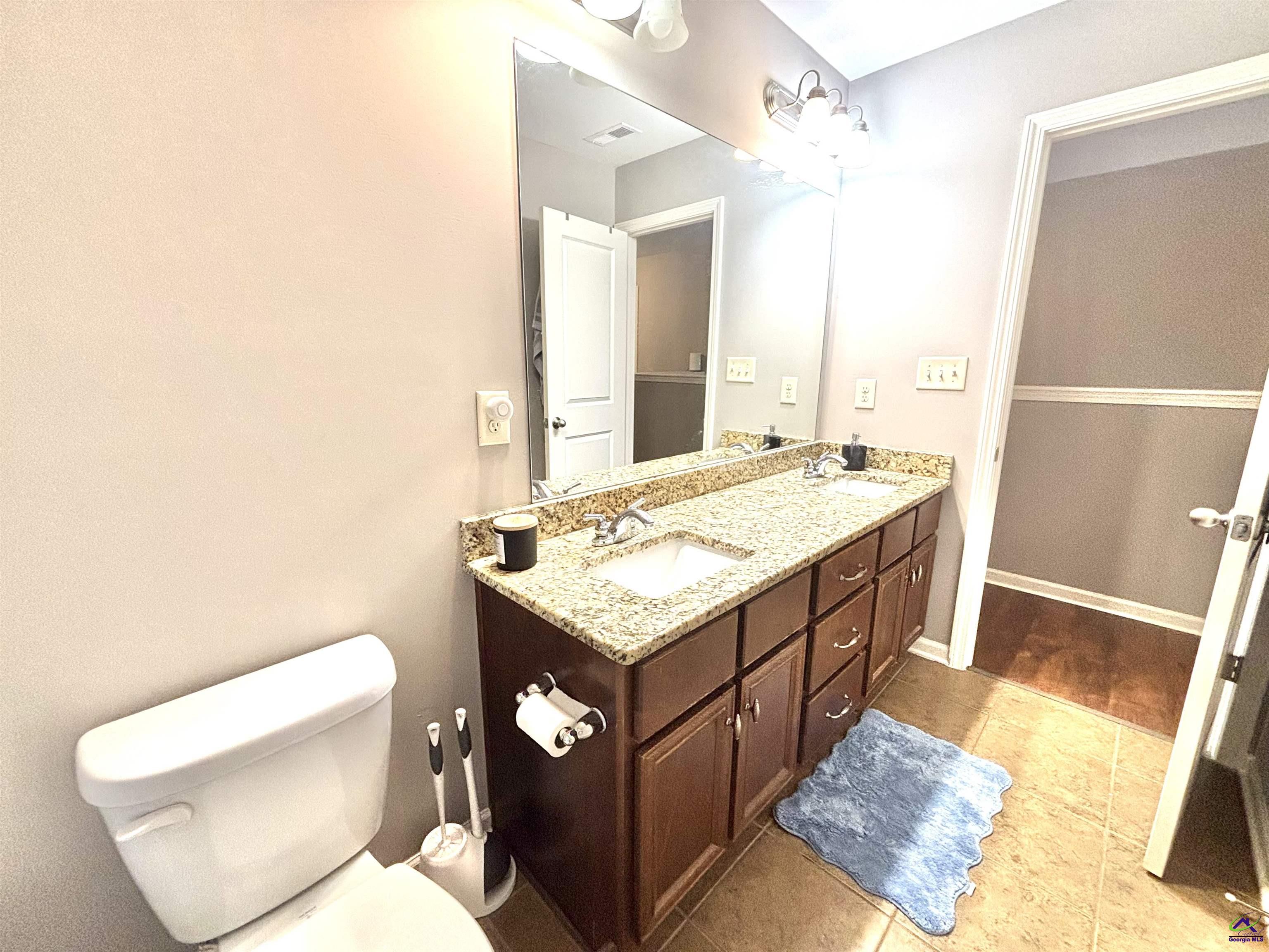 600 Post Oak Way Warner Robins, GA 31088 - Photo 43 of 50 a bathroom with a granite countertop sink and a toilet