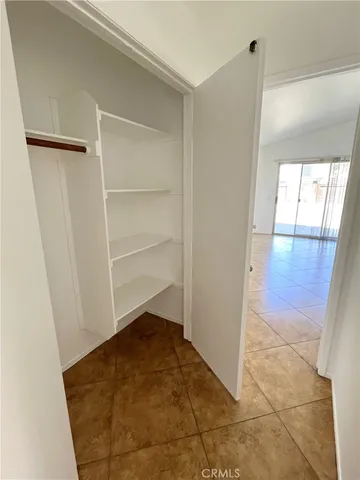 a view of an empty room and wooden floor