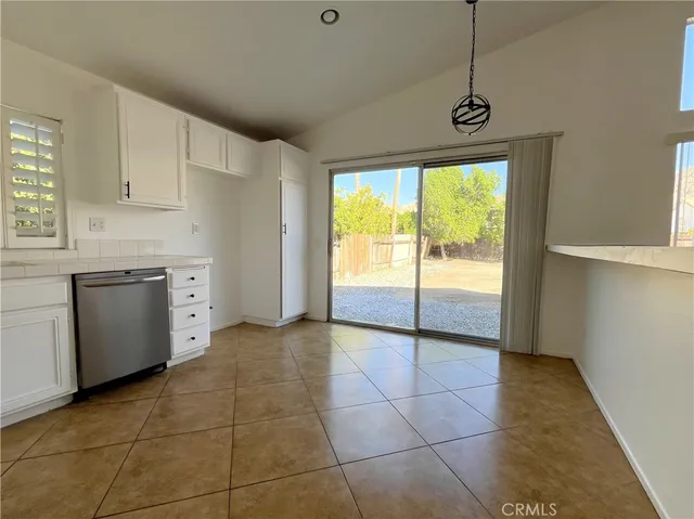 a view of a kitchen with wooden floor and a sink