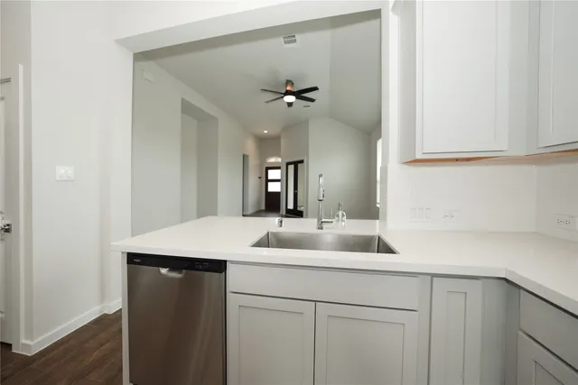 a kitchen with a sink and a mirror