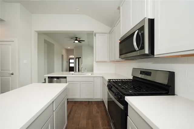 a kitchen with a stove and a microwave