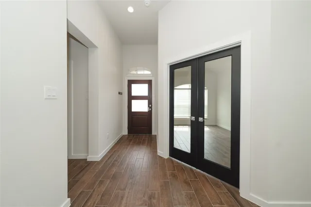 a view of hallway with wooden floor