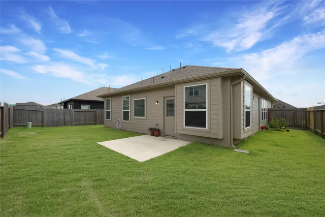 a front view of house with backyard and green space