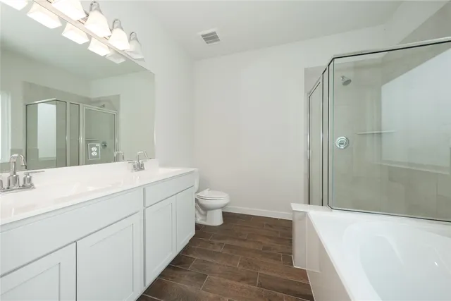 a spacious bathroom with a double vanity sink mirror double and shower