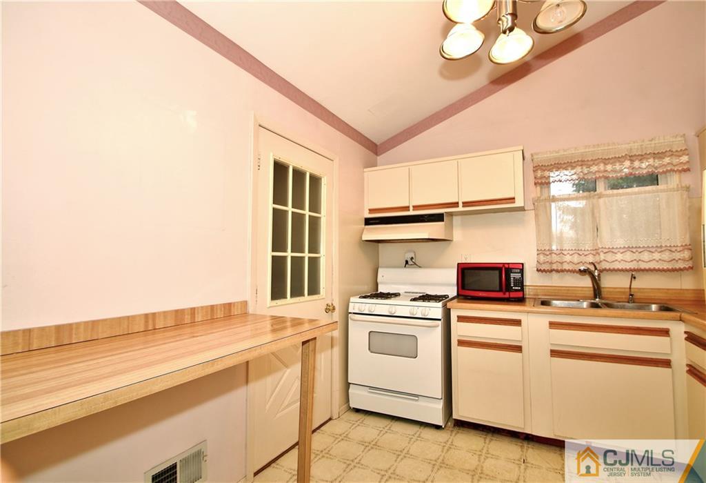 35 Rieder Road Spotswood, NJ 08884 - Photo 11 of 25 a kitchen that has a lot of white cabinets and wooden floor