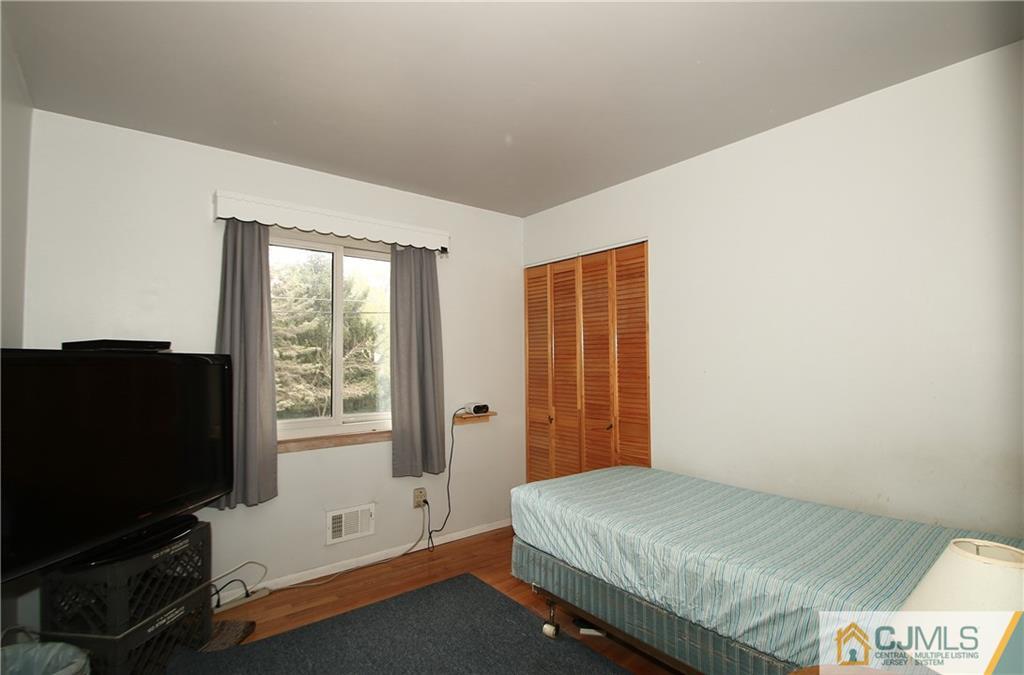 35 Rieder Road Spotswood, NJ 08884 - Photo 16 of 25 a bedroom with a bed and a flat screen tv