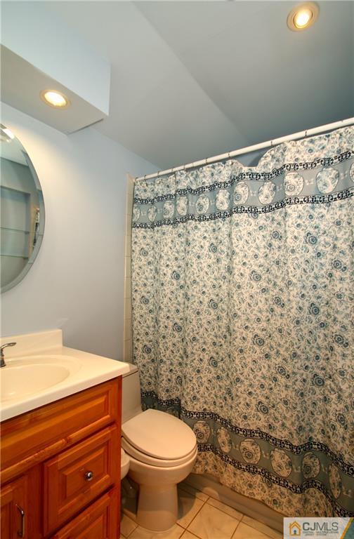 35 Rieder Road Spotswood, NJ 08884 - Photo 18 of 25 a bathroom with a toilet and a shower curtain