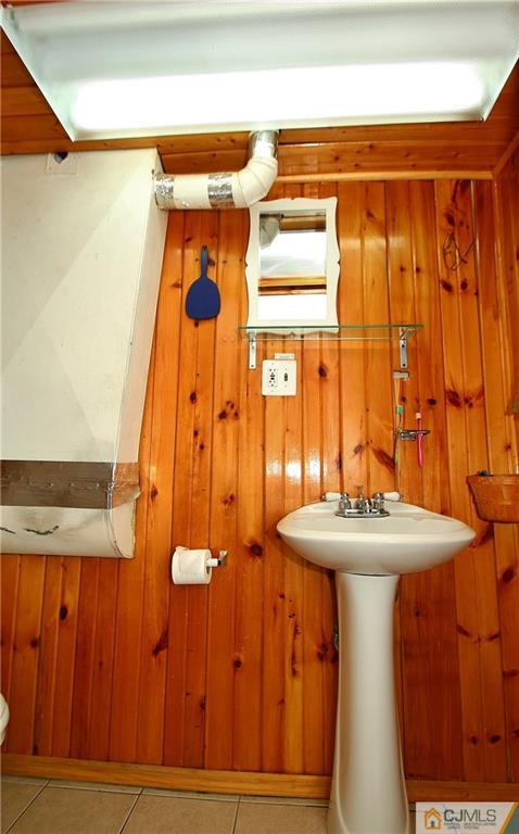 35 Rieder Road Spotswood, NJ 08884 - Photo 21 of 25 a bathroom with a sink a mirror and a shower