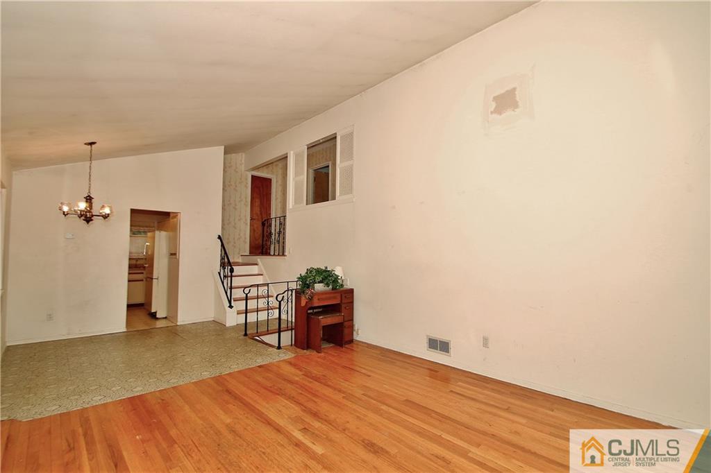 35 Rieder Road Spotswood, NJ 08884 - Photo 9 of 25 a view of a livingroom with wooden floor and a ceiling fan